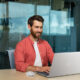 CGI-rendered Dell laptop and mouse integrated into a stock photo of a smiling businessman working at a desk in a modern office, created by Digital Imaging Group